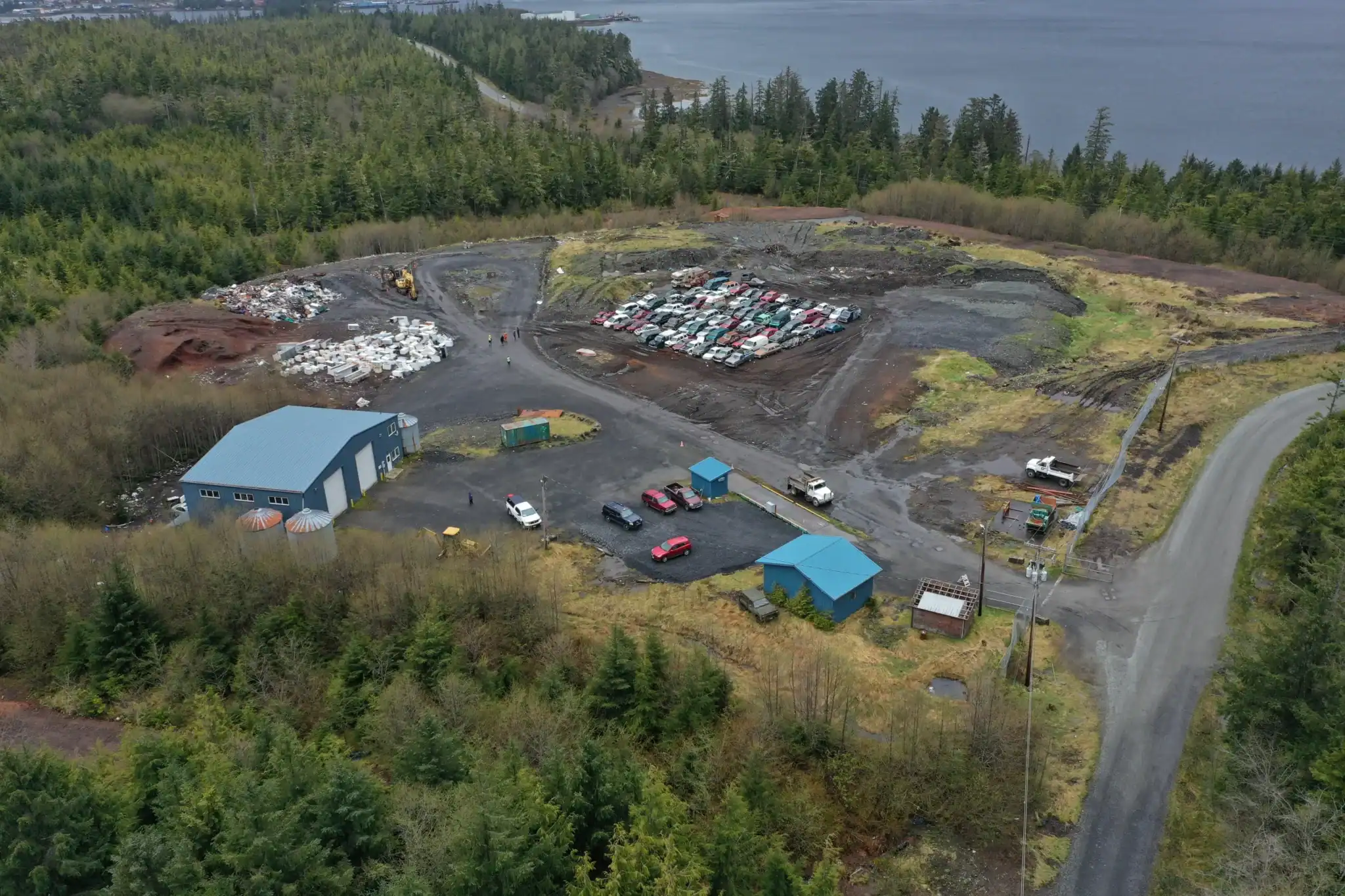 An aerial view of a landfill and a forest.